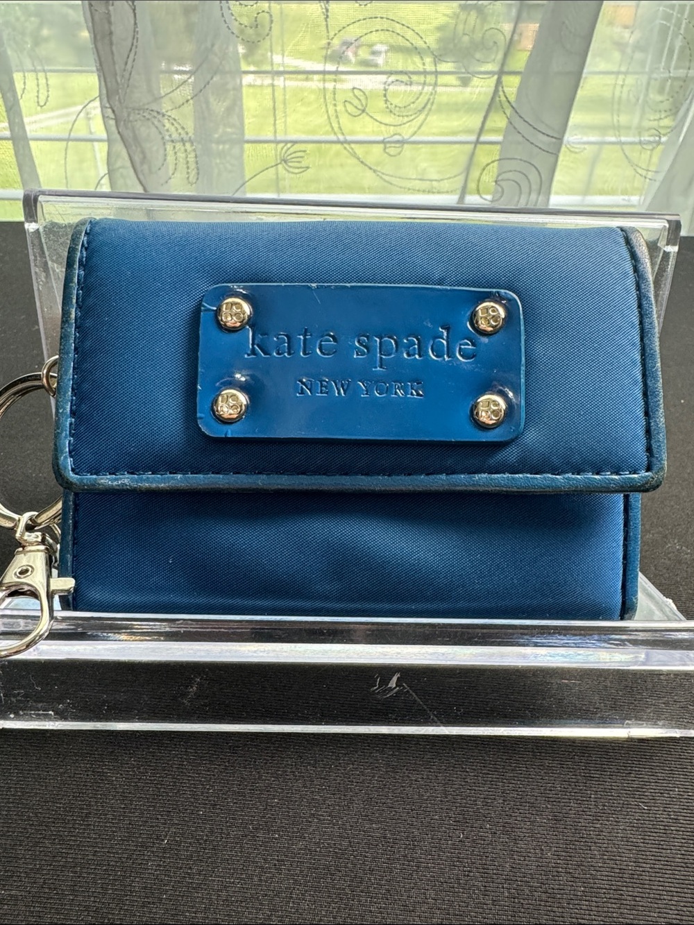kate spade blue compact flap wallet with gold-tone plaque